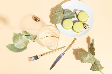 Pistachio cake makaroons and pistachios on a beige background. Top view.