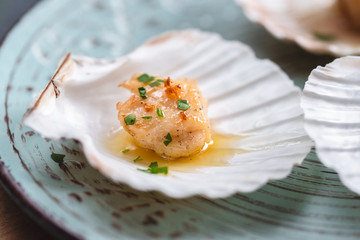 Seared scallops shell with butter, garlic and parsley.