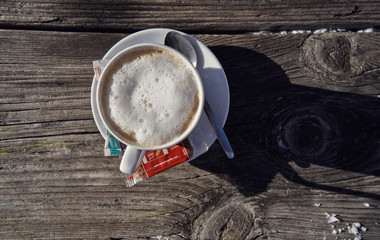 Brunnach Ski Resort, St. Oswald, Carinthia, Austria - January 20, 2019: Cup of coffee captured on an old wooden table