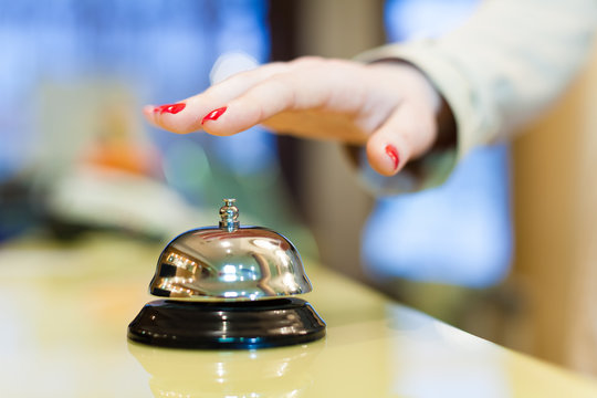 A Female Hand Ringing Silver Service Bell