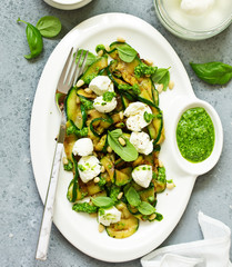 Grilled zucchini, mozzarella and pesto salad. Selective focus.
