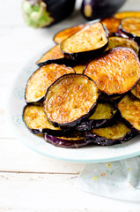 Fried eggplant on a plate on a wooden table