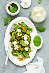 Grilled zucchini, mozzarella and pesto salad. Selective focus.