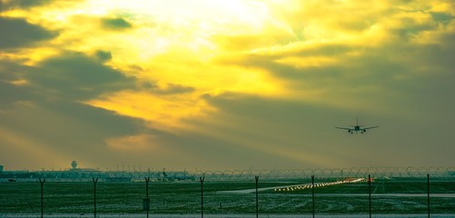 Fototapeta na wymiar Airport landscape landing plane at sunset 