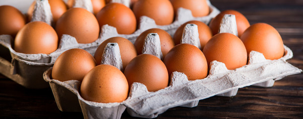 Fresh brown eggs on rustic table.