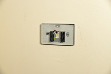 Thermostat wiring plate on wall