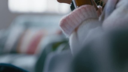 close up hands woman drinking coffee at home relaxing on couch sipping hot beverage 