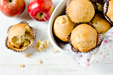 Apple muffins on a white wooden background