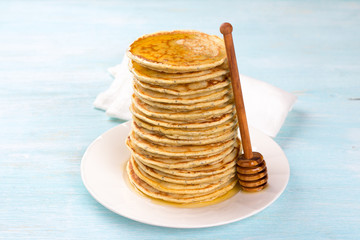 Lemon pancakes with poppy seeds and honey on a blue background. Delicious homemade food