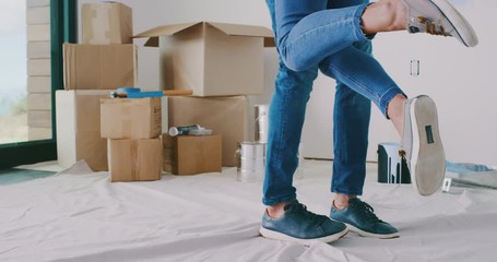 Happy husband spinning wife in his arms in new home, happy homeowners, home improvement - Powered by Adobe