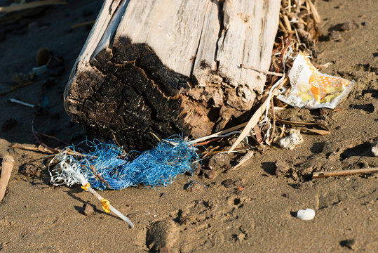 Plastic and litter material on sand beach