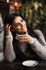Beautiful woman drinking coffee sitting in a cafe.