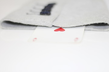 Concept image of a person hiding an ace up their sleeve.