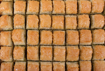 Baklava with walnut pistachios with a large table tray and a white striped scent