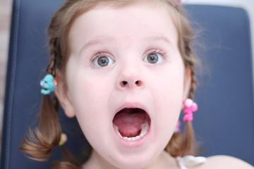 A cute little girl is enjoying playing at home