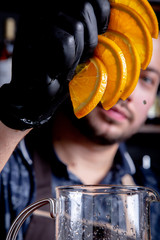 Preparation of citrus, orange tea by bartender