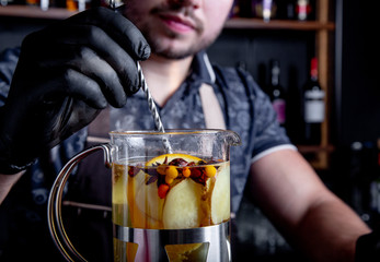 Process brewing tea,tea ceremony. Bartender preparing sea buckthorn tea