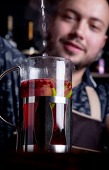 Process brewing tea,tea ceremony. Bartender pours hot water into the kettle to brew berry tea