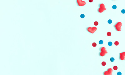 Valentine's Day background. Red hearts and confetti on pastel blue background. Valentines day concept, design. Flat lay, top view, copy space. - Image