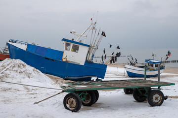 Fishing boats stretched out to the sea. Fishing port in Central Europe.