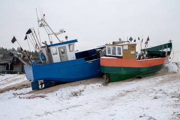 Fishing boats stretched out to the sea. Fishing port in Central Europe.