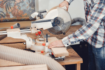 The carpenter works with a tree