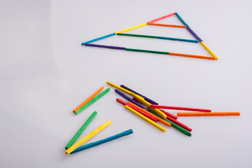 A triangle made of colorful sticks - 245443325