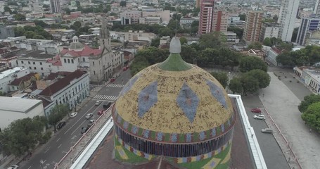 Aerial circling the dome of the Manaus Opera House in the Amazon, Brazil decorated with ceramic tiles using the colours of Brazil's national flag