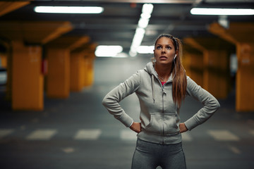 Fototapeta premium Young athlete woman is training in garage