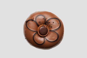 Chocolate glazed doghnut with chocolate cookie in middle on white background. High resolution image for food industry.