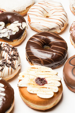 Multiple doughnuts on white background. High resolution image for food industry.