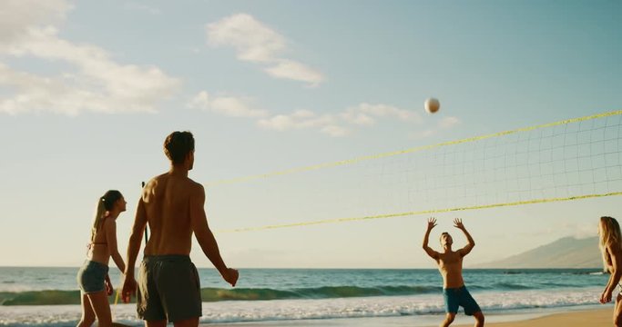 Active friends playing beach volleyball at sunset, cinematic slow motion, summer fun lifestyle