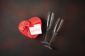 Valentine's Day with glasses box of chocolates in the form of a heart and a note. Top view with...
