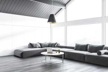 Gray attic living room corner, sofa and table