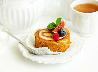 a piece of carrot cake with berries.