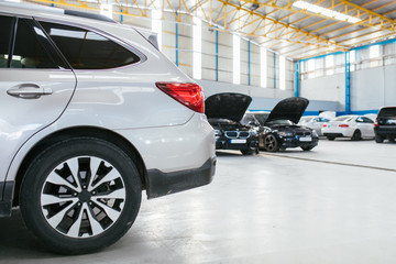 Fototapeta premium Modern Cars in repair maintenance auto service garage.