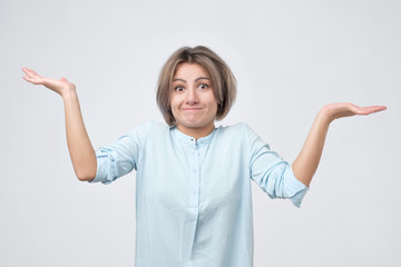 Young girl shrugging shoulders. I do not know why are you shouting on me.