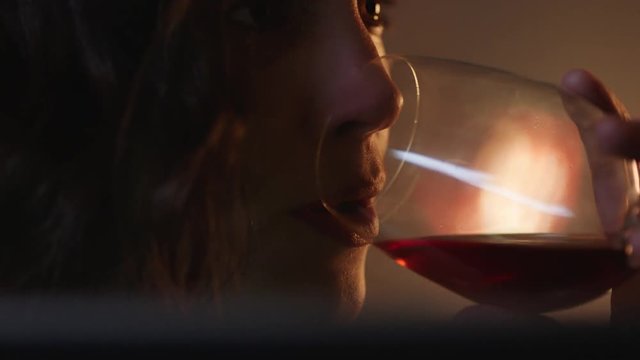 close up portrait unhappy woman crying watching sad movie using tablet computer looking at screen drinking wine at home experiencing break up