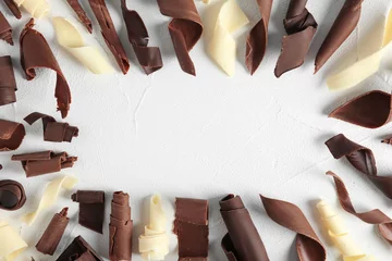 Foto op Plexiglas Flat lay composition with chocolate curls and space for text on light background © New Africa