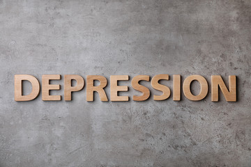 Word Depression made of wooden letters on gray background, top view