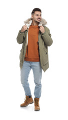 Fototapeta premium Young man wearing warm clothes on white background. Ready for winter vacation