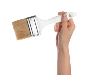 Woman holding paint brush on white background, closeup