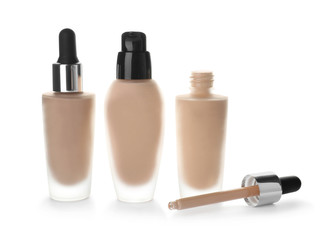 Bottles of different skin foundations on white background