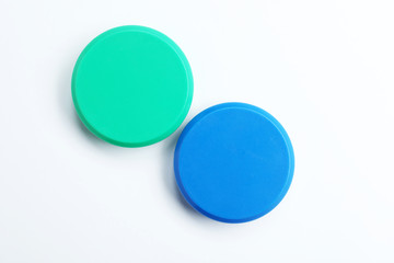 Bright magnets on white background, top view