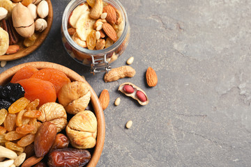 Flat lay composition of different dried fruits and nuts on color background. Space for text