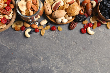 Composition of different dried fruits and nuts on color background, top view. Space for text