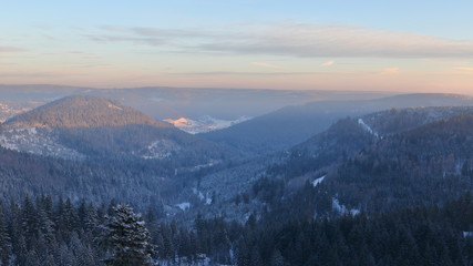 Obraz premium Sunrise over snowy Black Forest hills. Snowy pine tree forest.Sunrise in snowy hills.