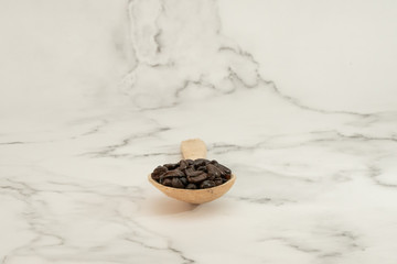 Wooden spoon with roasted coffee