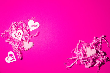 White wooden herarts on the pink sliced paper background. Valentines day collage