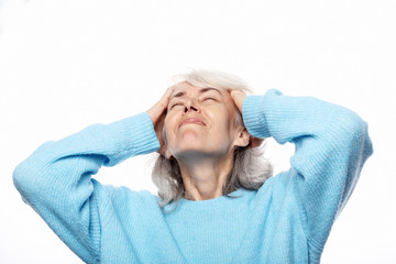 Lifestyle, health  and people concept: senior lady having headache over white background